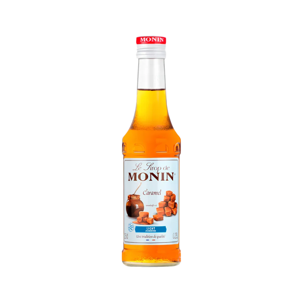 Monin Caramel Light syrup in 250ml clear glass bottle with rich amber-orange liquid and blue label showing illustrated caramel candy cubes and a caramel pot, on white background